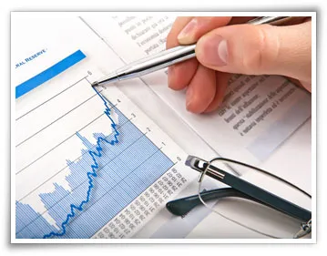 hand with pen and a financial sheet