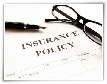 dental insurance policy sheet with a pen and glasses on top