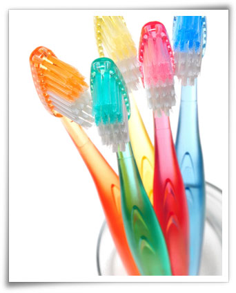 tooth brushes on a glass